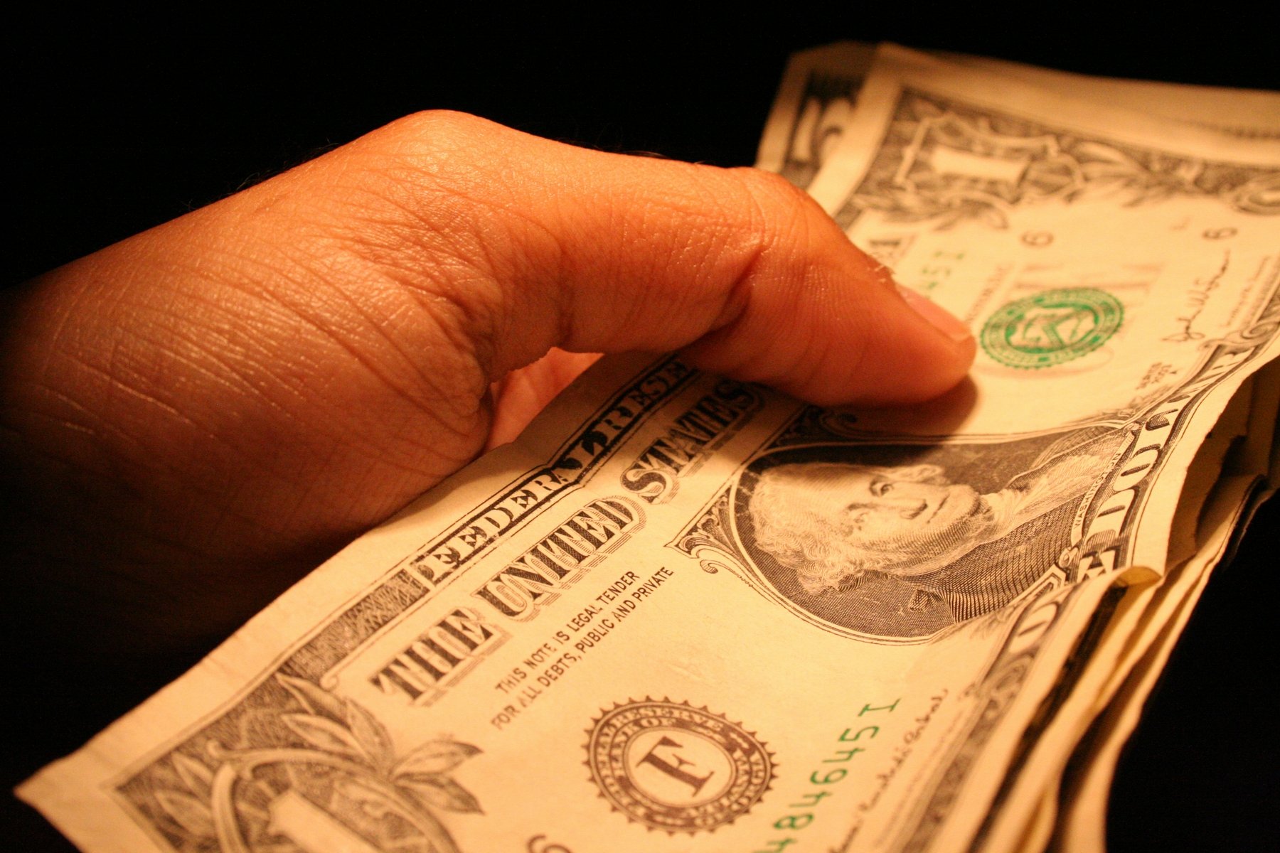 Hand holding dollar bills